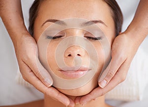 Woman, face or massage at spa from above for beauty, skincare treatment or healing at cosmetics salon. Happy client