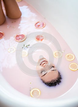 Woman face in milk bath. Spa skin care concept. Healthy Face and rejuvenation.