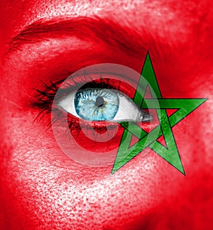 Woman face painted with flag of Morocco