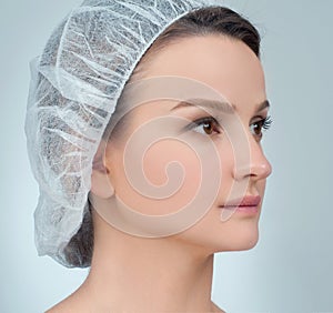 Woman face after plastic surgery. Anti-aging treatment and face lift.