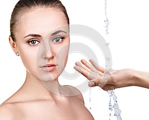 Woman face and pouring water in hand.