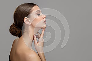 Woman face profile side view. Chin lift pointing with index finger