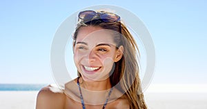 Woman, face and relaxing at beach on holiday, smiling and vacation at sea or laughing on tropical adventure. Happy