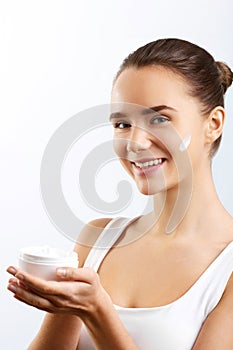 Skincare. Beauty Concept. Young Pretty Woman Holding Cosmetic Cream.Girl wiht fresh skin,