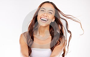 Woman, face skincare and windy hair on white background in studio for keratin treatment, healthcare wellness or color