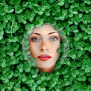 Woman face surrounded by grass
