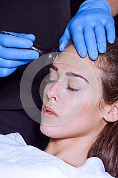Woman face treatment at medical center