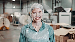 Woman, face and warehouse worker for packaging manufacturing with hair net, hygiene or distribution. Female person