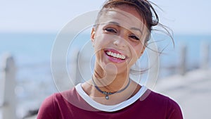 Woman, face or windy hair by beach, ocean or sea in travel location, Portugal summer break or holiday vacation. Portrait