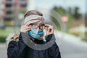 Woman with facemask and tarnished glasses, corona concept