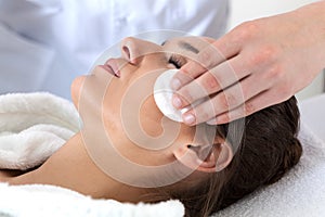 Woman during facial cleansing in spa
