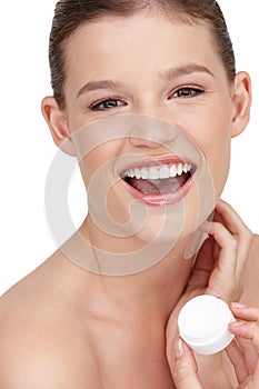 Woman, facial cream and smile in studio portrait for cosmetics, skincare or beauty exfoliation. Female person, clean and