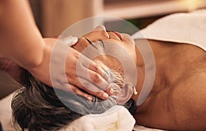 Woman, facial and head massage at spa for beauty, skincare treatment and healing at cosmetics salon. Face of calm mature