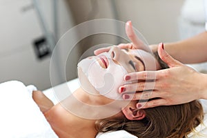 Woman with facial mask in beauty salon