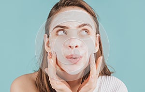 Woman facial mask, face clay. Funny woman with cosmetic facial procedure, spa skin concept. Skin care beauty treatment