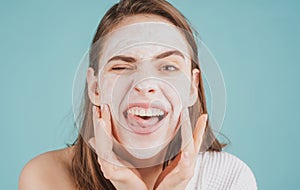 Woman facial mask with fun, face clay. Funny woman with cosmetic facial procedure, spa skin concept. Skin care beauty