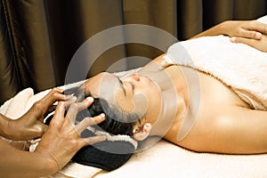 Woman in facial massage treatment