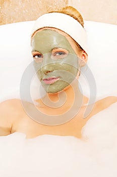 Woman with facial mud mask. Dayspa photo