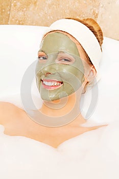 Woman with facial mud mask. Dayspa