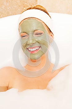 Woman with facial mud mask. Dayspa