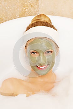 Woman with facial mud mask. Dayspa