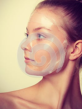 Woman in facial peel off mask.