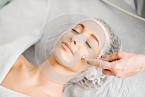 Woman during the facial treatment procedure