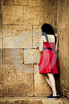 Woman facing stonewall photo
