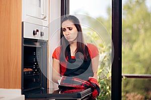 Woman Failing at Baking Some Muffins in the Oven