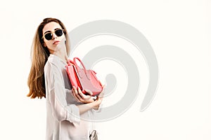 Woman with fancy female bag. Lady holds pink purse.