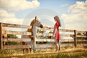 Woman on the farm with her horse