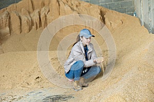 Woman farmer checking quality of soybean husk