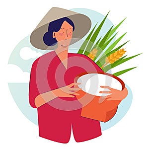 Woman farmer holding basket wearing cap in rice padi field harvesting. Traditional farming organic nature