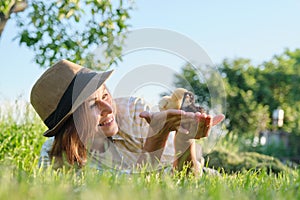 Woman farmer holding in hands two small newborn baby chickens