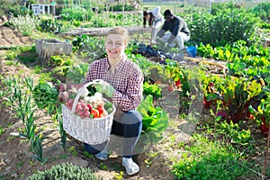 woman farmer holding wicker basket