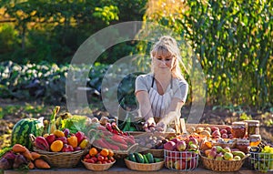 A woman farmer sells fruits and vegetables at a farmers market. Selective focus.