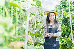 Woman farmer is standing arms crossed and smiling