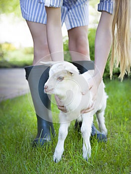 Woman farmer and young goat