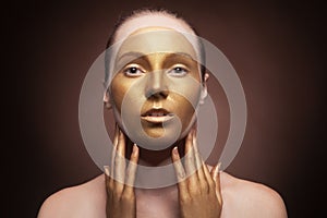 Woman with fashion art make up on brown background