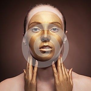 Woman with fashion art make up on brown background