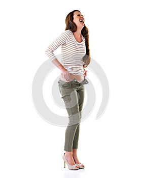 Woman, fashion and laugh in studio for casual, pants and cool clothes on white background. Female person, smile and