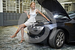 Woman, fashion and portrait on car engine for repair with spanner for maintenance for breakdown, mechanical or oil leak