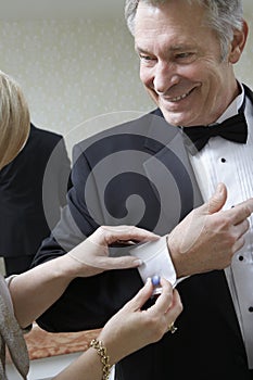 Woman Fastening Husband's Cufflink photo