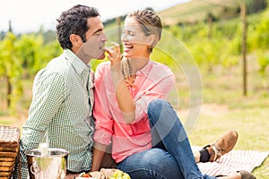 Woman feeding man with grape photo