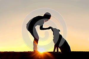 Woman Feeding Pet Dog Treats Silhouette photo