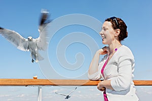 Woman feeds seagulls.