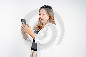 woman feel disgusted and shocked while looking at her mobile phone