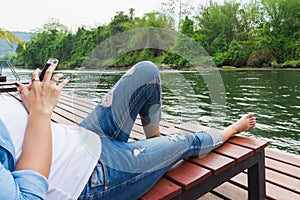 Woman is feel relax and play internet mobile