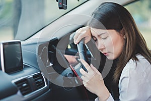 Woman feel tried and sleeping on a car