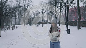 Woman feeling cold in park covered in snow with copy space